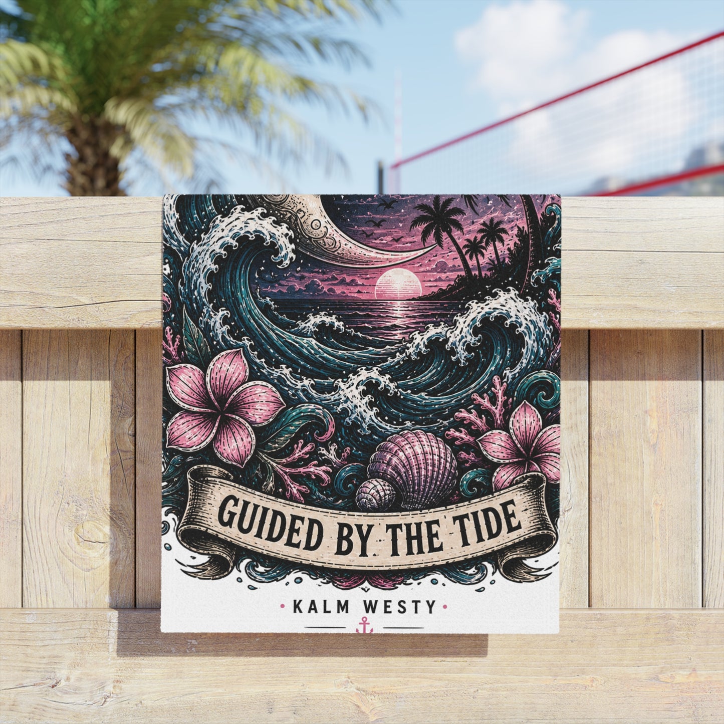 Beach towel with Guided by the Tide moon and waves sunset design featuring hibiscus flowers draped over a timber fence.