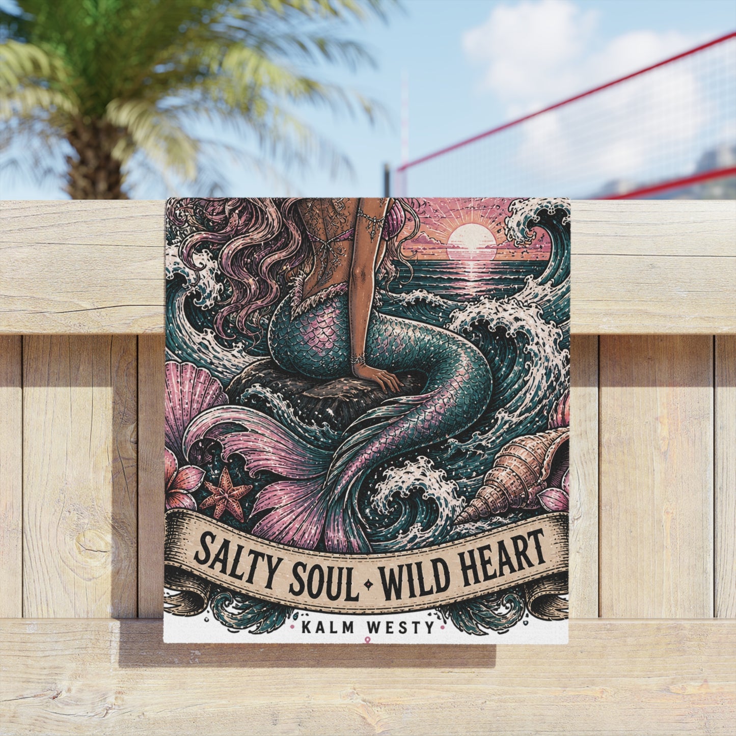 Mermaid beach towel with vintage sunset, ocean waves, and "Salty Soul Wild Heart" text on wooden fence, outdoors.