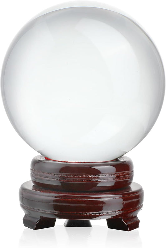 80mm clear K9 crystal ball for photography and divination, displayed on a polished dark wood stand on a white background.