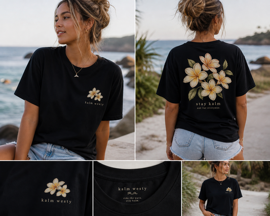 Oversized black coastal tee with yellow frangipani floral print and 'stay kalm' graphic on chest and back.