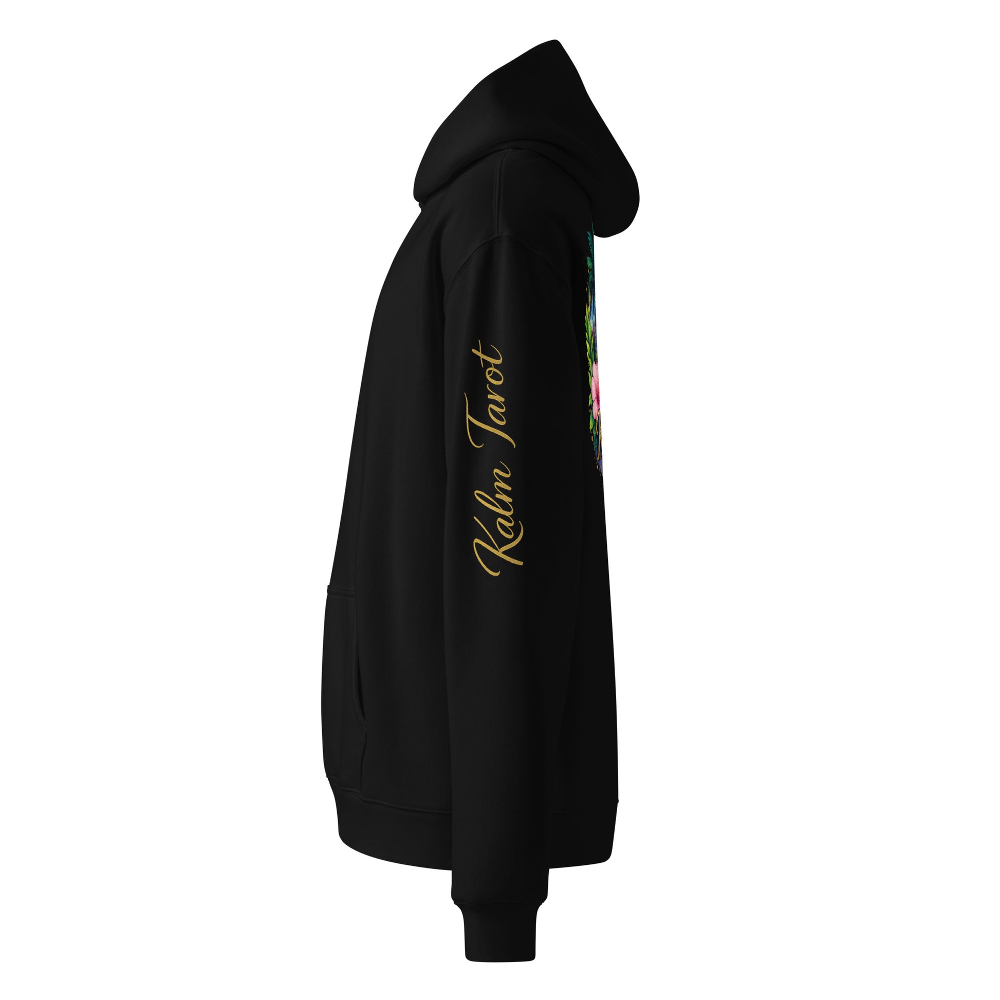 Side view of black oversized Kalm Tarot hoodie with gold sleeve script and mystic moon graphic on back.